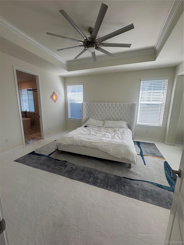 bedroom with ornamental molding, a tray ceiling, carpet floors, baseboards, and ceiling fan