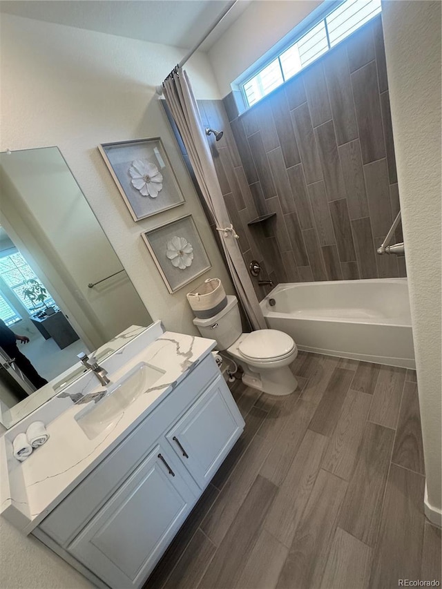 bathroom with toilet, shower / bath combo with shower curtain, vanity, and wood finished floors