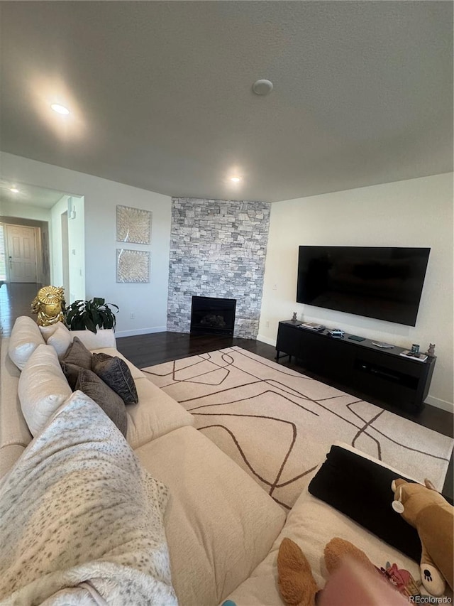 living room with baseboards, a fireplace, wood finished floors, and recessed lighting