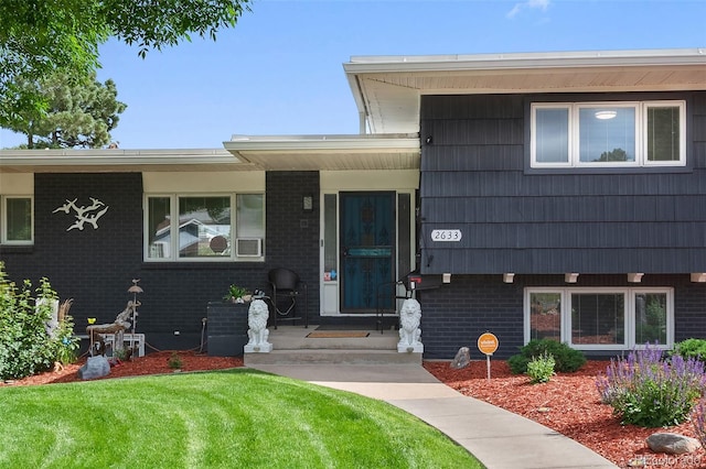 2633 Summit Dr, Colorado Springs, CO 80909 - doorway to property with brick siding and a yard