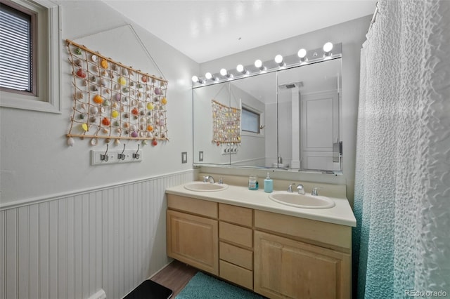 2633 Summit Dr, Colorado Springs, CO 80909 - bathroom with double vanity and wainscoting