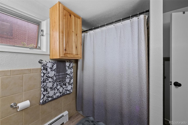 2633 Summit Dr, Colorado Springs, CO 80909 - bathroom featuring tile walls, curtained shower, and a baseboard heating unit