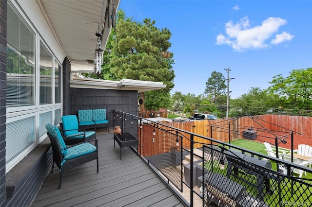 2633 Summit Dr, Colorado Springs, CO 80909 - wooden terrace featuring an outdoor living space and a fenced backyard
