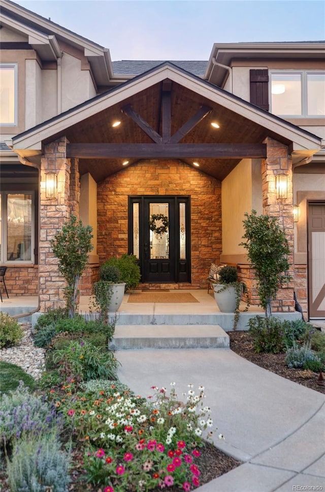 exterior entry at dusk featuring a porch