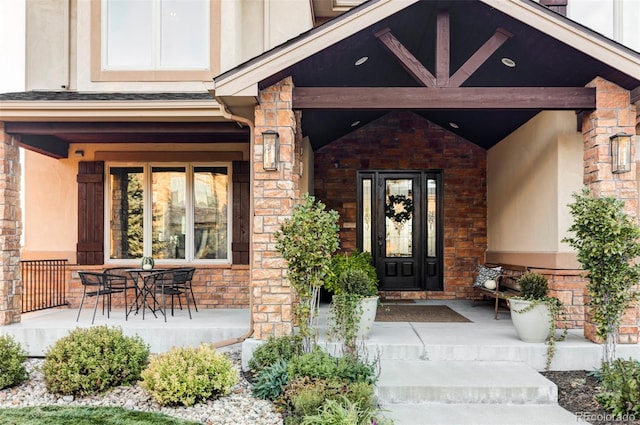 view of exterior entry featuring a porch