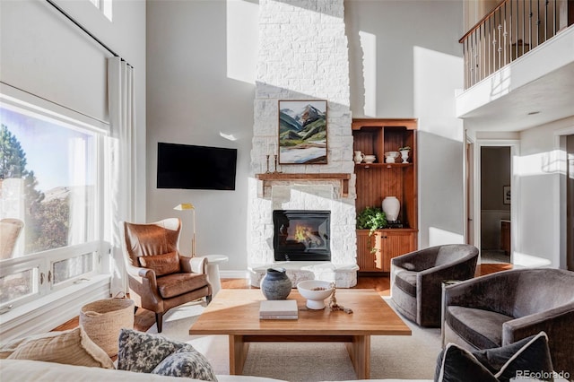 living room with a fireplace and a towering ceiling