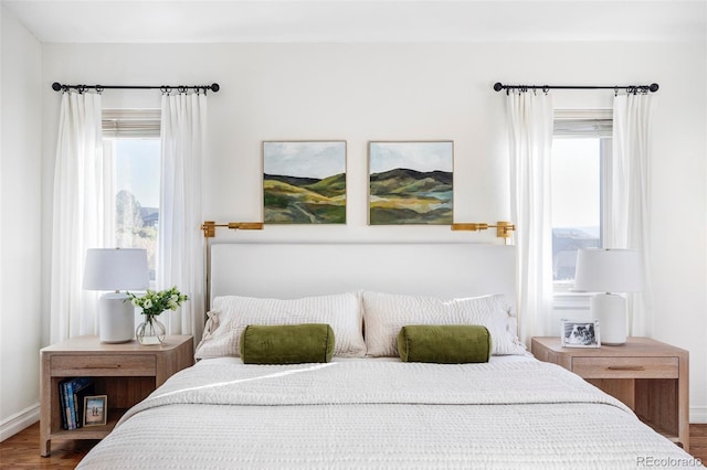 bedroom featuring hardwood / wood-style floors and multiple windows