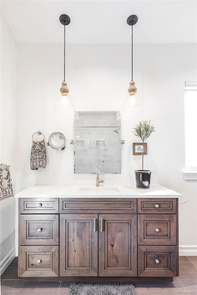 bar featuring pendant lighting, dark brown cabinetry, and sink