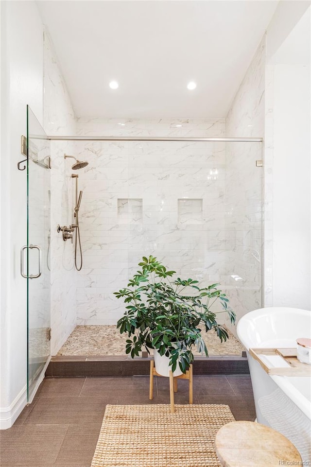 bathroom with tile patterned flooring and independent shower and bath