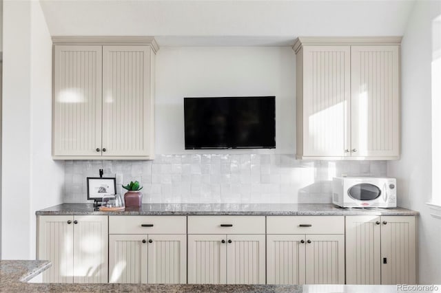 kitchen with decorative backsplash and light stone countertops