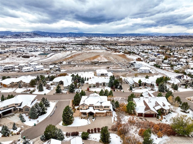 snowy aerial view featuring a mountain view