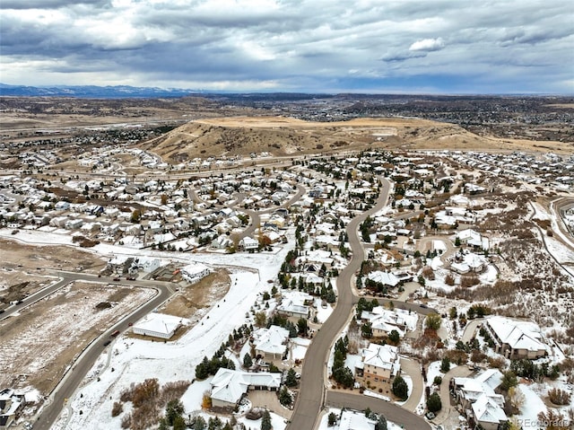 snowy aerial view with a mountain view