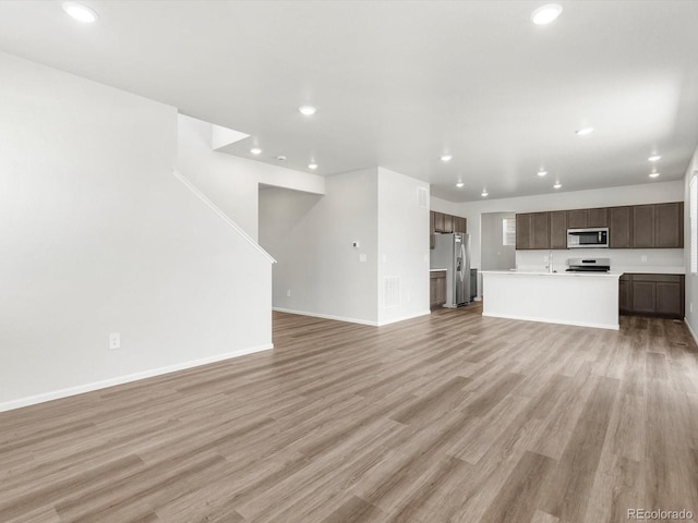 4635 Goldflower Dr, Johnstown, CO 80534 - unfurnished living room featuring recessed lighting and light wood finished floors