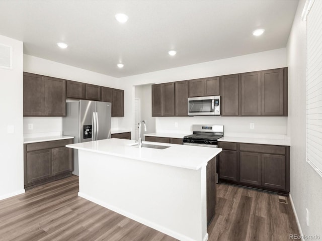 4635 Goldflower Dr, Johnstown, CO 80534 - kitchen featuring appliances with stainless steel finishes, dark wood-type flooring, dark brown cabinetry, and recessed lighting