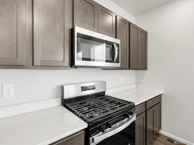 4635 Goldflower Dr, Johnstown, CO 80534 - kitchen with appliances with stainless steel finishes, dark brown cabinetry, and light countertops