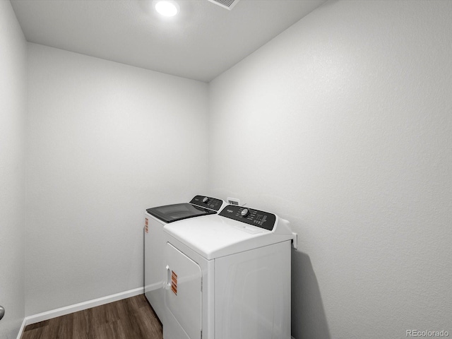 4635 Goldflower Dr, Johnstown, CO 80534 - washroom featuring separate washer and dryer and dark wood-style flooring