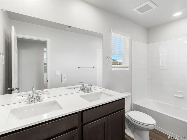 4635 Goldflower Dr, Johnstown, CO 80534 - bathroom featuring double vanity, wood finished floors, and shower / bathtub combination