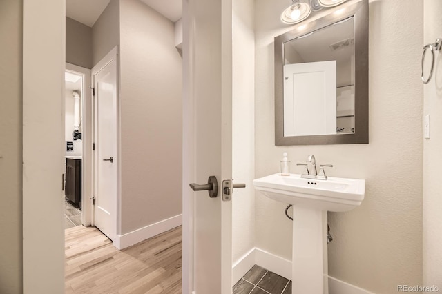2442 S Bannock St, Denver, CO 80223 - bathroom featuring wood finished floors and baseboards