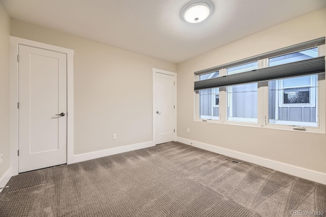 2442 S Bannock St, Denver, CO 80223 - carpeted empty room featuring baseboards and healthy amount of natural light