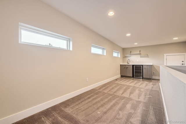 2442 S Bannock St, Denver, CO 80223 - indoor wet bar featuring beverage cooler, light carpet, baseboards, and recessed lighting