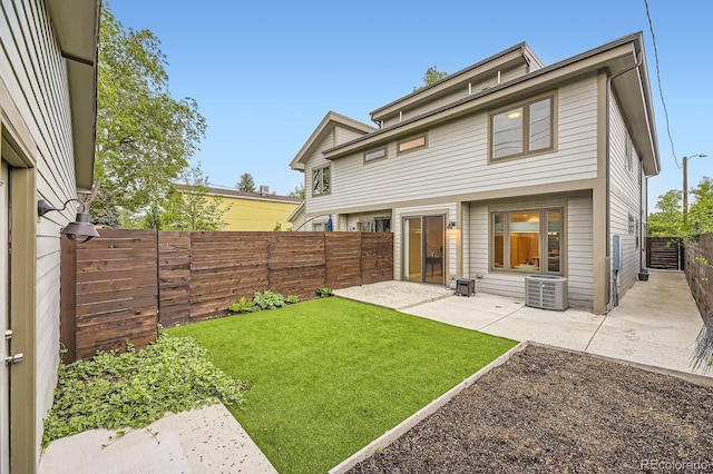 2442 S Bannock St, Denver, CO 80223 - rear view of property with central AC and a patio area