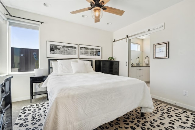 bedroom with a barn door, baseboards, recessed lighting, light carpet, and ceiling fan
