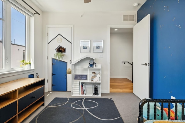 carpeted bedroom with multiple windows