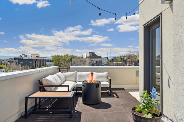 balcony with a fire pit and a view of city