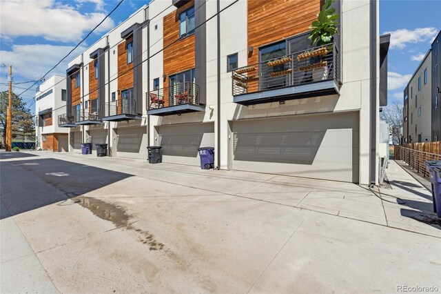 view of property with an attached garage and concrete driveway