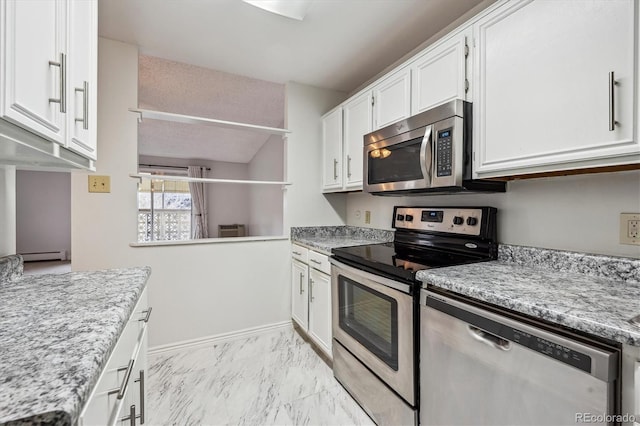 kitchen with white cabinetry, appliances with stainless steel finishes, light stone counters, and baseboard heating