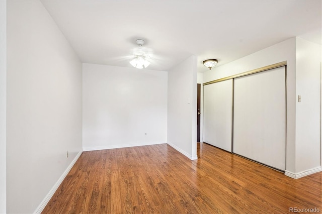 unfurnished bedroom with hardwood / wood-style floors and a closet