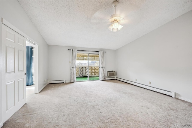 spare room featuring light carpet, a baseboard radiator, and a textured ceiling