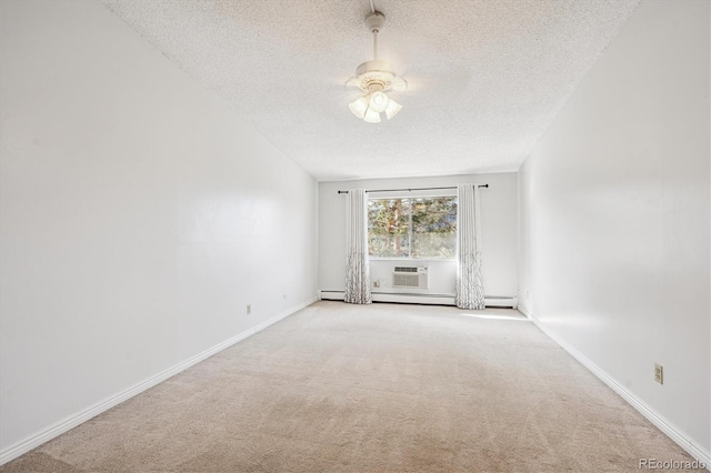 carpeted spare room featuring baseboard heating, ceiling fan, and a textured ceiling