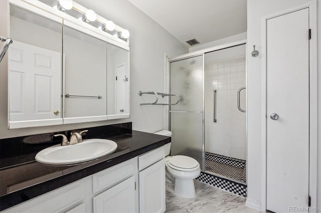 bathroom with vanity, toilet, and a shower with shower door