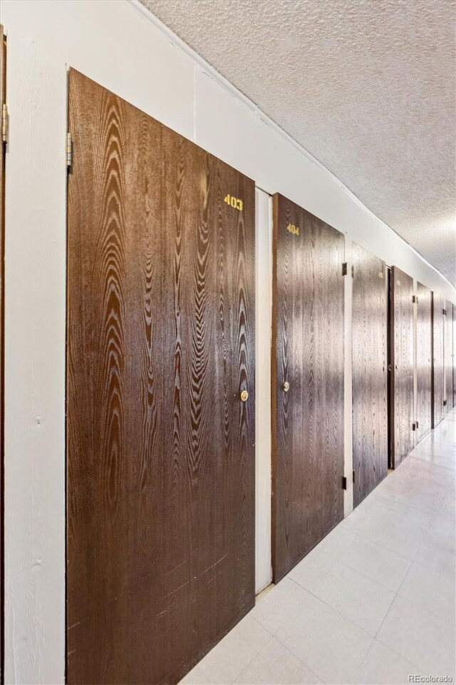 hall with a textured ceiling