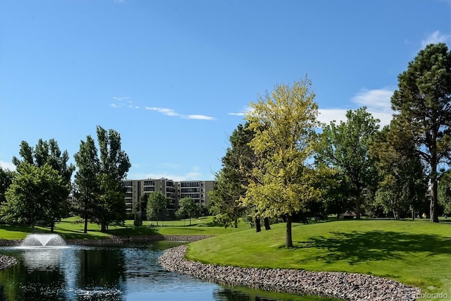 surrounding community featuring a yard and a water view