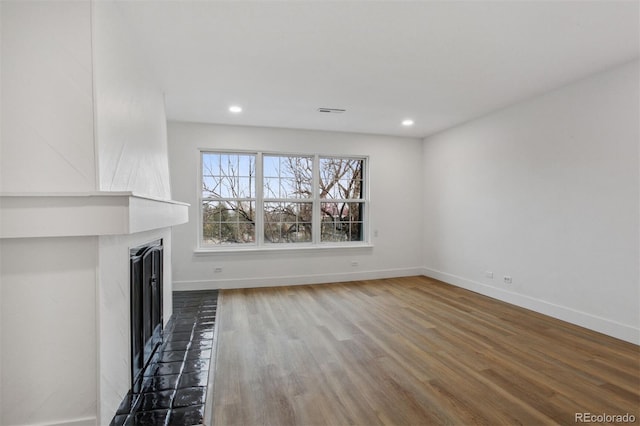 9120 E Girard Ave Unit 12, Denver, CO 80231 - unfurnished living room featuring a fireplace, wood finished floors, and recessed lighting