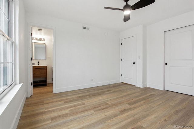 9120 E Girard Ave Unit 12, Denver, CO 80231 - unfurnished bedroom featuring light wood-style floors, ensuite bathroom, a closet, and ceiling fan