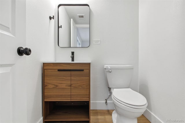 9120 E Girard Ave Unit 12, Denver, CO 80231 - half bath featuring vanity and wood finished floors