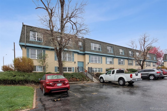 9120 E Girard Ave Unit 12, Denver, CO 80231 - view of building exterior featuring uncovered parking and a residential view