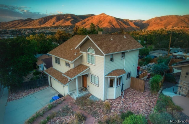 420 Sunshine Pkwy, Golden, CO 80403 - rear view of house with fence, a garage, a mountain view, and roof with shingles