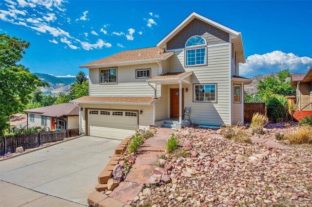 420 Sunshine Pkwy, Golden, CO 80403 - view of front of home featuring fence, concrete driveway, an attached garage, and a mountain view