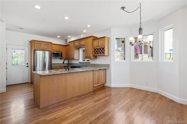 420 Sunshine Pkwy, Golden, CO 80403 - kitchen featuring appliances with stainless steel finishes, a chandelier, a peninsula, a sink, and baseboards