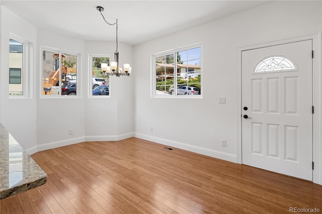 420 Sunshine Pkwy, Golden, CO 80403 - foyer entrance featuring a chandelier, baseboards, and light wood-style flooring