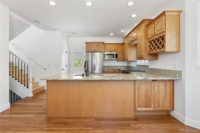 420 Sunshine Pkwy, Golden, CO 80403 - kitchen featuring appliances with stainless steel finishes, a sink, light stone counters, baseboards, and recessed lighting