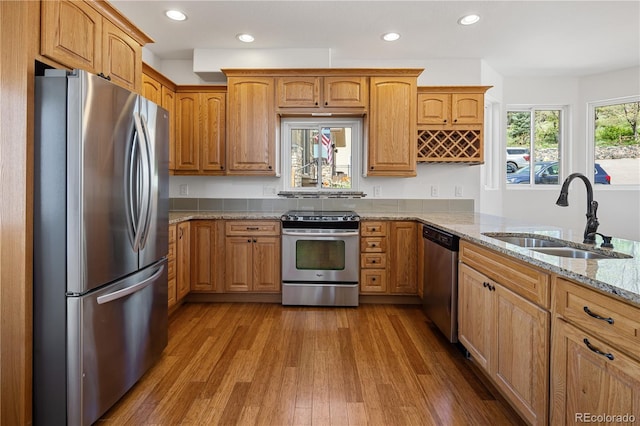 420 Sunshine Pkwy, Golden, CO 80403 - kitchen featuring appliances with stainless steel finishes, a sink, light stone counters, wood finished floors, and recessed lighting