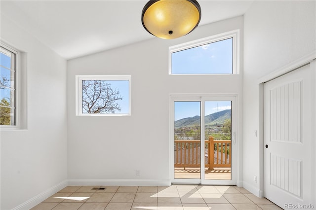 420 Sunshine Pkwy, Golden, CO 80403 - unfurnished room featuring light tile patterned flooring, a mountain view, baseboards, and high vaulted ceiling