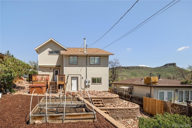 420 Sunshine Pkwy, Golden, CO 80403 - back of house featuring a deck with mountain view, fence, a garden, and stairway