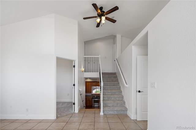 420 Sunshine Pkwy, Golden, CO 80403 - stairway with tile patterned floors, a ceiling fan, high vaulted ceiling, and baseboards