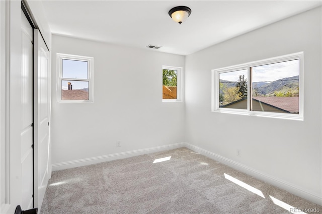 420 Sunshine Pkwy, Golden, CO 80403 - unfurnished bedroom featuring multiple windows, baseboards, carpet flooring, and a closet
